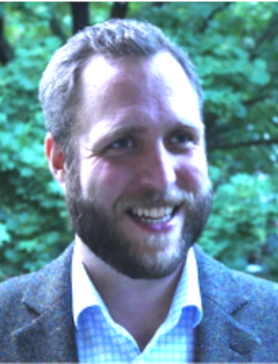 portrait of Simon Varga standing in front of a tree